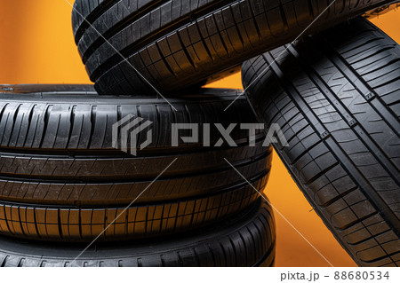 Car tires isolated on yellow background, close up 88680534