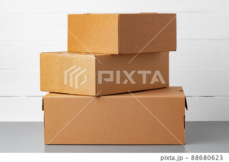 Group of cardboard boxes against white wooden wall 88680623