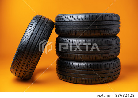 Car tires isolated on yellow background, close up 88682428
