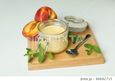 Concept of healthy food with peach yogurt on white background 88682715