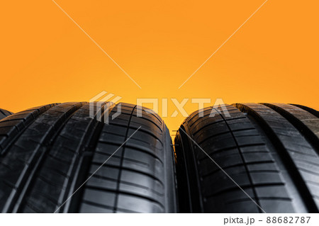 Car tires isolated on yellow background, close up Car tires isolated on yellow background, close up 88682787