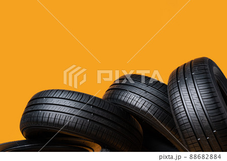 Car tires isolated on yellow background, close up 88682884