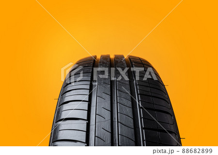 Car tires isolated on yellow background, close up Car tires isolated on yellow background, close up 88682899