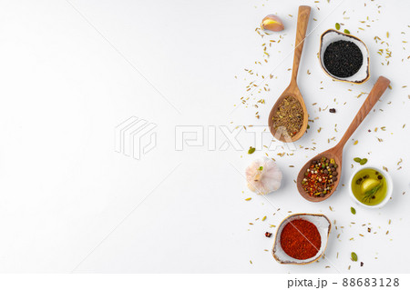 Colorful spices in the wooden spoons on white background. Colorful spices in the wooden spoons on white background. 88683128