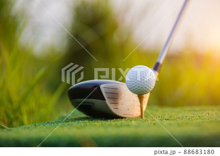Golf club and ball on green grass ready to be struck on golf course background Golf club and ball on green grass ready to be struck on golf course background 88683180