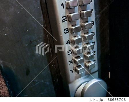 Grey silver number keypads security door locker on black door Grey silver number keypads security door locker on black door 88683708