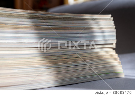 A stack of magazines against a gray background. Close-up of old print editions. 88685476