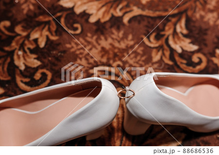 Beautiful diamond ring on women's shoes. Close-up. Wedding accessories 88686536