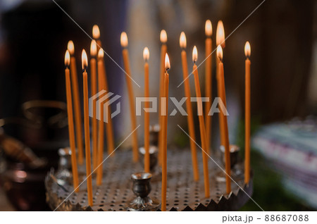 Wedding decoration in the church, candles, blurred background. Traditions Wedding decoration in the church, candles, blurred background. Traditions 88687088