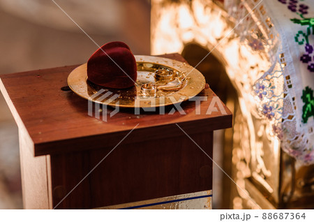 Wedding rings on a golden plate 88687364