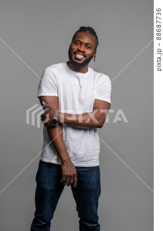 Happy guy with his wristwatch standing by the gray wall Happy guy with his wristwatch standing by the gray wall 88687736