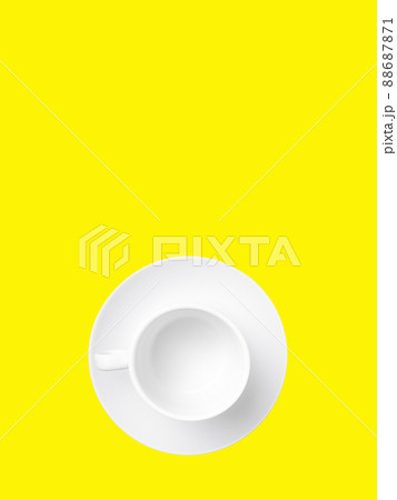 Flat lay. Empty white cup on a saucer isolated on a yellow background. Flat lay. Empty white cup on a saucer isolated on a yellow background. 88687871