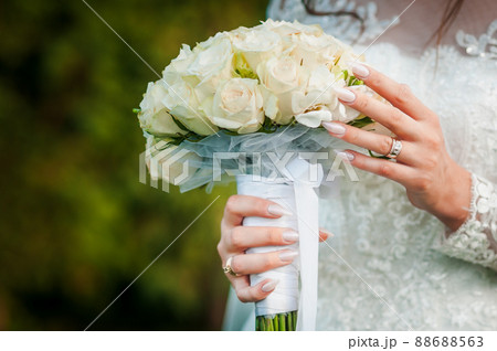 Bouquet of flowers in the hand of the bride Bouquet of flowers in the hand of the bride 88688563