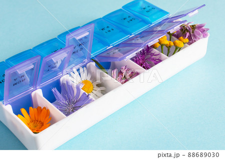Various kinds of medical herbs in a pills organizer. Alternative medicine concept. 88689030