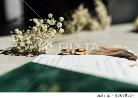 Bridal bouquet and wedding rings on window 88689557