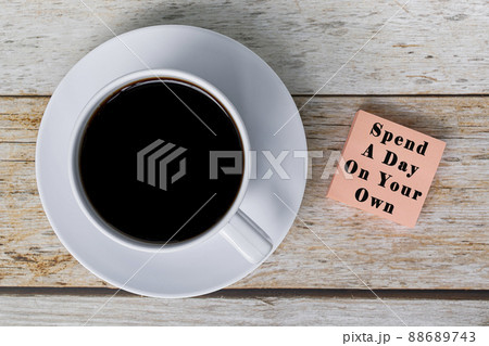 Motivational quote on notepad with white coffee cup on wooden desk. 88689743