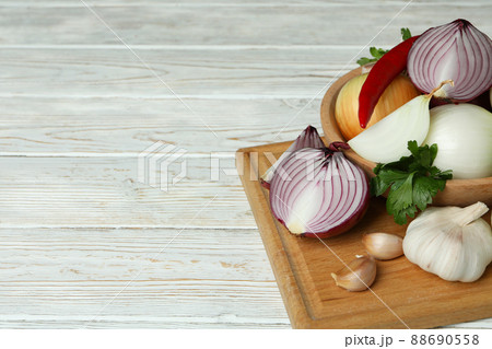 Different spicy vegetables on white wooden background Different spicy vegetables on white wooden background 88690558