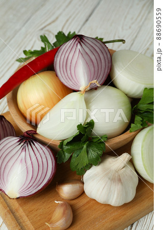 Different spicy vegetables on white wooden background Different spicy vegetables on white wooden background 88690559