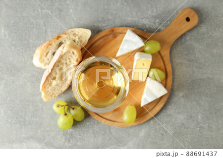 Concept of tasty eating with white wine on gray textured table 88691437