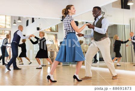 Pair dancing lindy hop during rehearsal Pair dancing lindy hop during rehearsal 88691873
