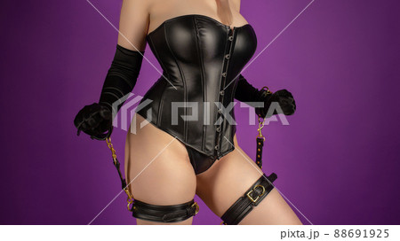 Beautiful young woman in a leather corset and bondage set posing 88691925