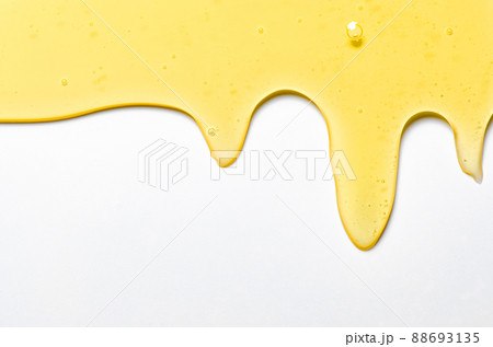 Fresh honey or synthetic oil or vegetable oil. White background. Copy space. 88693135