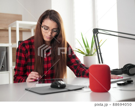 young woman working at home on desktop pc and digital tablet 88694050