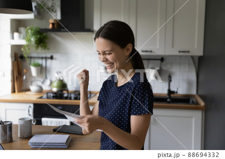 Woman read letter smiling feels satisfied by great news 88694332