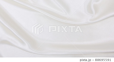 Smooth elegant white silk or satin luxury cloth texture as wedding background. Luxurious background design Smooth elegant white silk or satin luxury cloth texture as wedding background. Luxurious background design 88695591
