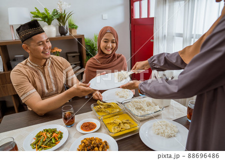 serving food for friend for iftar dinner or eid mubarak 88696486