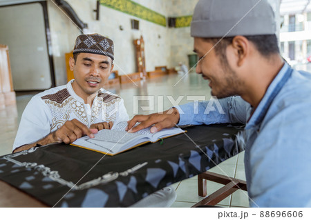 Man muslim learing to reading quran together during ramadan Man muslim learing to reading quran together during ramadan 88696606
