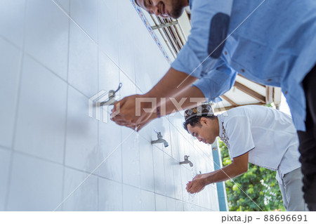 Man muslim perform ablution or wudu at the mosque 88696691