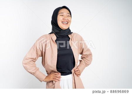 happy asian muslim woman stand with hands on hip and laugh happy asian muslim woman stand with hands on hip and laugh 88696869