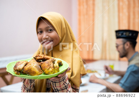 muslim mother serving some food for family dinner 88696922