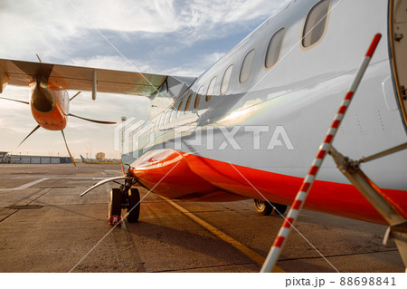 Passenger airplane under cloudy sky at airport 88698841