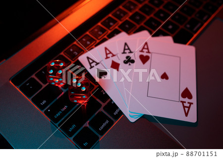 Dice and cards on a laptop, casino online concept 88701151