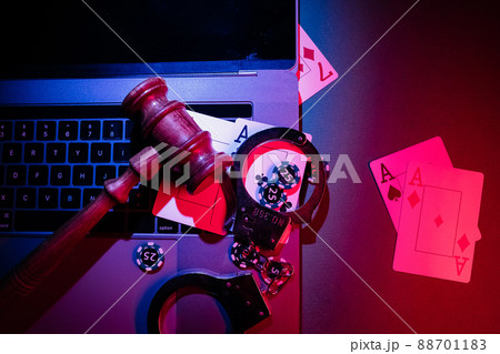 Chips, cards and wooden gavel on the laptop. Online casino and gambling concept Chips, cards and wooden gavel on the laptop. Online casino and gambling concept 88701183