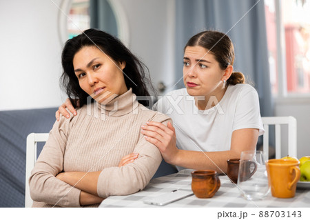 Young woman comforting her depressed female friend 88703143