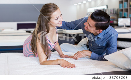 Man and woman choosing mattress Man and woman choosing mattress 88703203