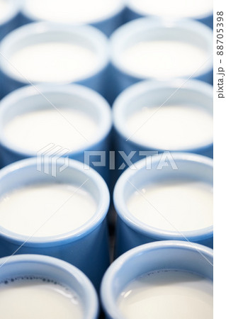 Jars of milk ready for ripening and turning into yogurt. The process of producing homemade yogurt. Vertical photo. Jars of milk ready for ripening and turning into yogurt. The process of producing homemade yogurt. Vertical photo. 88705398