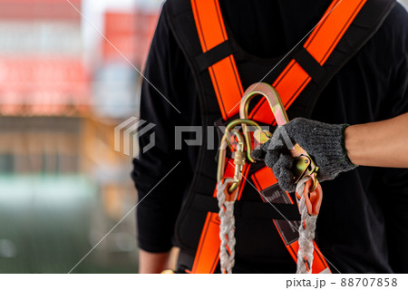 Construction worker wearing safety harness and safety line Construction worker wearing safety harness and safety line 88707858