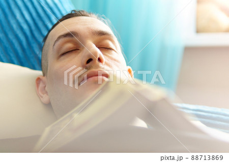 Man sleeping with the book on the sofa close up. Selective focus 88713869