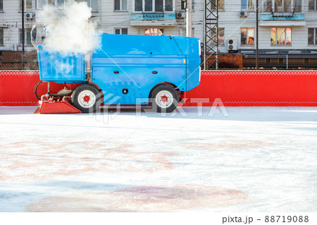 An ice cleaning machine polishes the ice rink at the stadium. 88719088