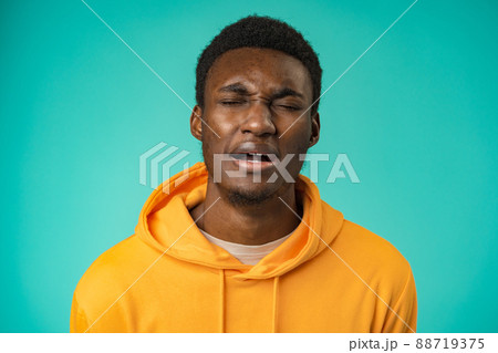 Portrait of young handsome afro-american guy sadly looking at camera in studio 88719375