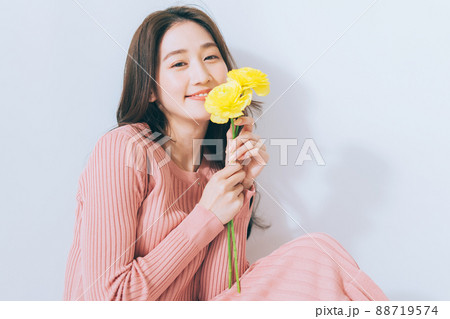 黄色の花を持つ女性 88719574