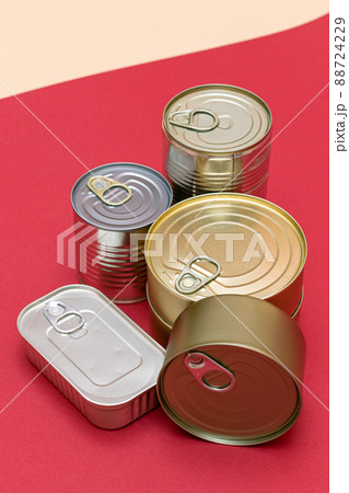 Unopened Tin Cans with Blank Edges on Red Background 88724229