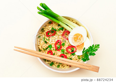 Beautiful Noodle Dish with Green Onions, Eggs, Red Hot Pepper and Greens 88724234