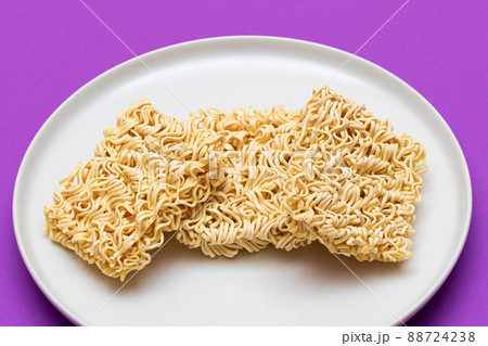 Uncooked Instant Noodles on White Plate Uncooked Instant Noodles on White Plate 88724238