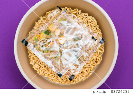 Opened Package with Uncooked Instant Noodles on Violet Background Opened Package with Uncooked Instant Noodles on Violet Background 88724255
