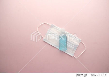 Surgical masks, and hand sanitizer on light purple background Surgical masks, and hand sanitizer on light purple background 88725563